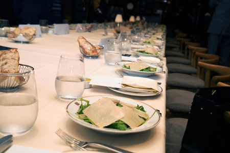 Restaurant table set with crostini, cheese, spinach and bread