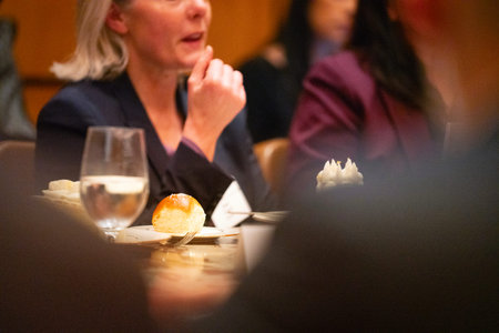 Close up of a woman eating a cake in a restaurant with a blurred background