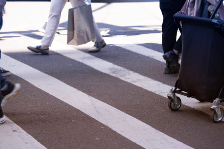 people walking in zebra crosswalk,shallow depth of field