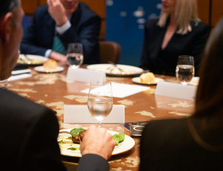 Group of business people having dinner in a restaurant. Focus on the table