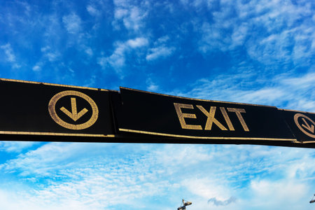 Exit sign on blue sky with white clouds. Concept of travel and vacation.