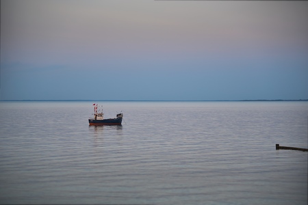 a small fishing boat on the seaの写真素材