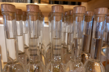 a lot of alcohol bottles in a shelfの写真素材