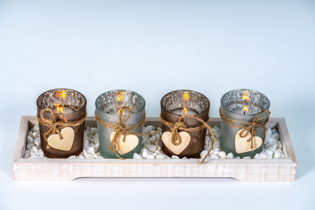 four candlesticks decorated with a heartの写真素材