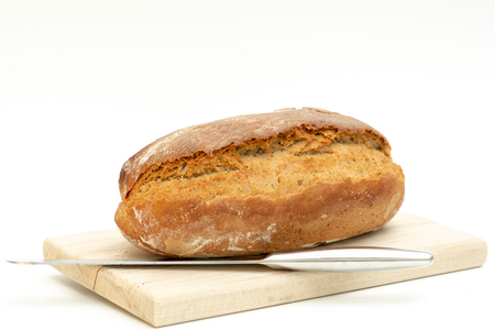 freshly baked bread lies on a wooden boardの写真素材