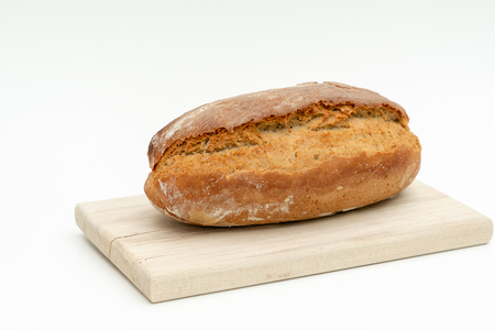 freshly baked bread lies on a wooden boardの写真素材