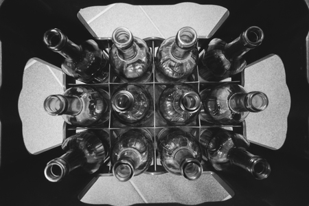a crate with empty glass bottlesの写真素材