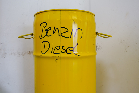 a yellow metal barrel with the inscription petrol and dieselの写真素材