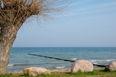 long groynes protrude into the water of the blue Baltic Seaの写真素材