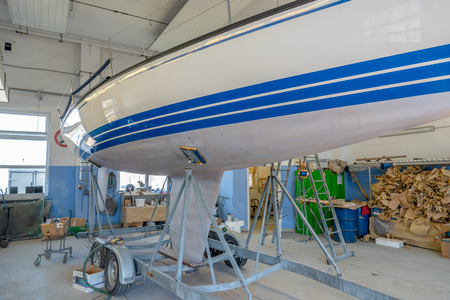a sailing ship stands in a paint shop to be repaintedの写真素材