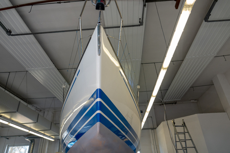 a sailing ship stands in a paint shop to be repaintedの写真素材