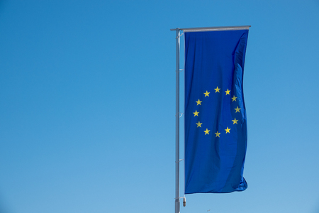 a flag of the European Union waving before a blue skyの写真素材