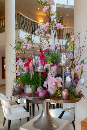 an artfully arranged Easter arrangement stands in the foyer of a hotelの写真素材