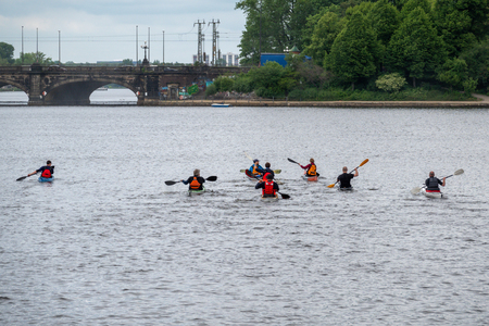 a group of canoeists breaks out for a trip on the waterの写真素材