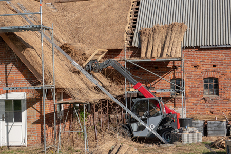 an old farmhouse is newly covered with reed