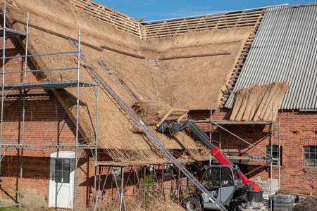 an old farmhouse is newly covered with reedの写真素材