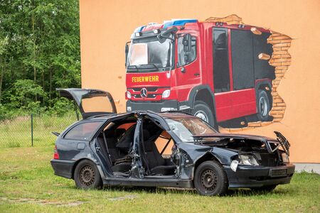 on the premises of the fire brigade there is a wrecked car that is used for training purposesの写真素材