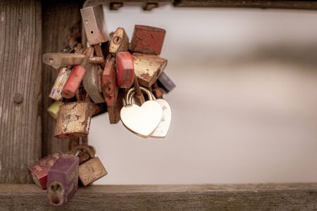 Padlocks in different colours hanging from a pierの写真素材