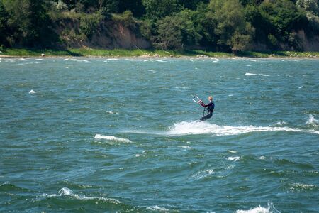 Kite surfers race across the seaの写真素材