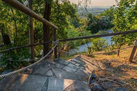 a Tuscan landscape in the background and a stone staircase in the foregroundの写真素材