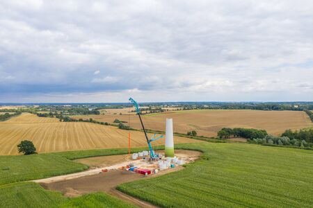 new wind turbines will be erected on a fieldの写真素材