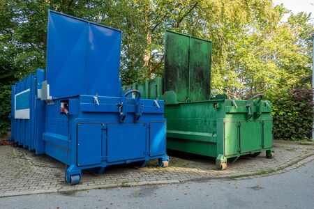 two garbage compactors Standing next to each other on the premises of a hospitalの写真素材