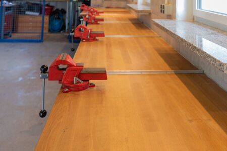 some red vices I find on a workbench in a children's workshopの写真素材