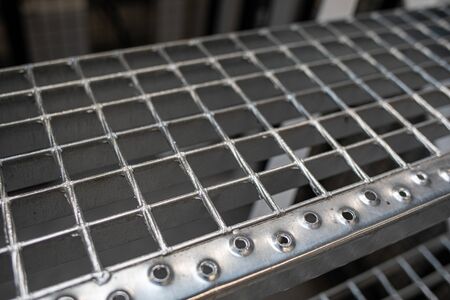 A metal floor and stairs are located in a factory hall.の写真素材
