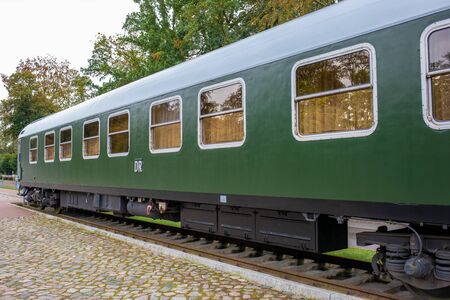 an old historical train of the Deutsche Reichsbahn from the times of the GDR stands on a sidingの写真素材