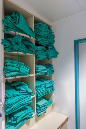 in a dressing room in a surgical ward in a hospital the green surgical clothing is lyingの写真素材