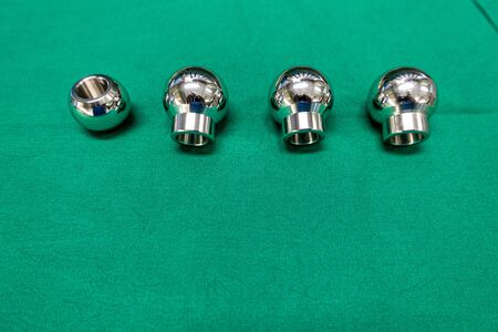 an explanted femoral prosthesis lies on a green surgical drapeの写真素材