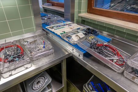 in a sterilization department in a hospital are many instrument trays that still need to be packedの写真素材