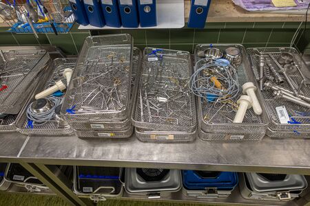 in a sterilization department in a hospital are many instrument trays that still need to be packedの写真素材