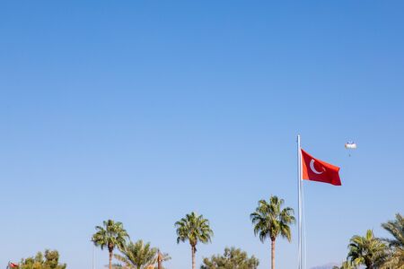 in the port of Side the Turkish flag blows at a mastの写真素材