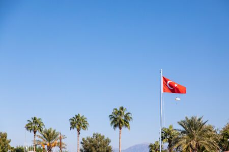 in the port of Side the Turkish flag blows at a mastの写真素材
