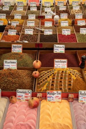 many vessels filled with spices in various colors are offered from an oriental bazaarの写真素材