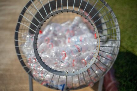 plastic bottles are collected in a metal basketの写真素材