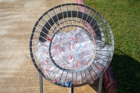 plastic bottles are collected in a metal basketの写真素材