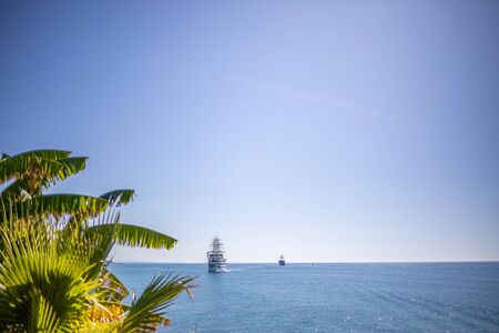 a sailing ship anchors in the port of Side in fine weatherの写真素材