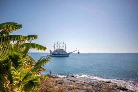 a sailing ship anchors in the port of Side in fine weatherの写真素材