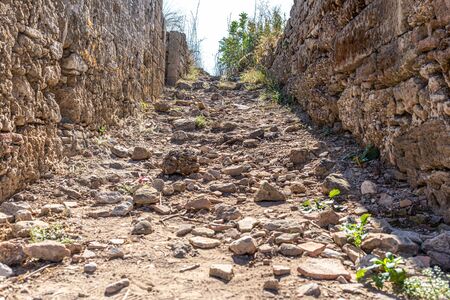 a stone staircase leads through a passageway down to the seaの写真素材