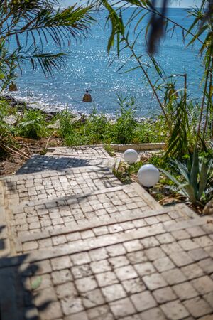 a stone staircase leads through a passageway down to the seaの写真素材