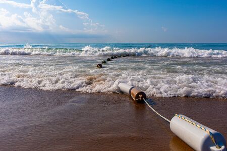 at the beach a barrier line leads into the sea with the best weather and waves