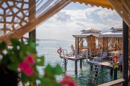  wooden walkway leads across the blue sea in fine weather