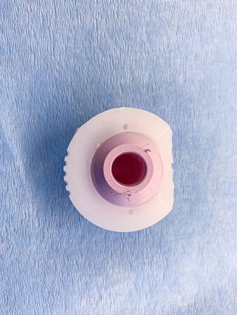 a duo head hip prosthesis is placed on a light blue cloth, with the cup made of plastic and the head made of ceramicsの写真素材