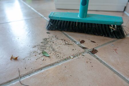 dirt swept with a broom is lying on the floorの写真素材