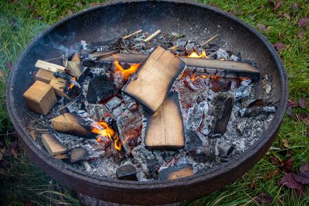 A small fire burns in a fire bowl.の写真素材