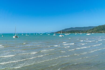 at the beach of Arlie Beach in Australia you can see many sailboats lying in the bayの写真素材