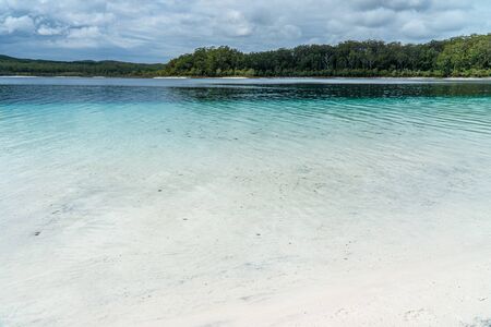 the turquoise blue water of a lake on Fraser Island in Australiaの写真素材