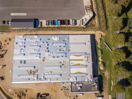 Insulation is installed on the roof of a newly built factory building